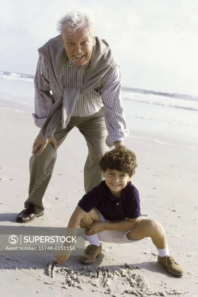 Portrait of a grandson playing with his grandfather on the beach
