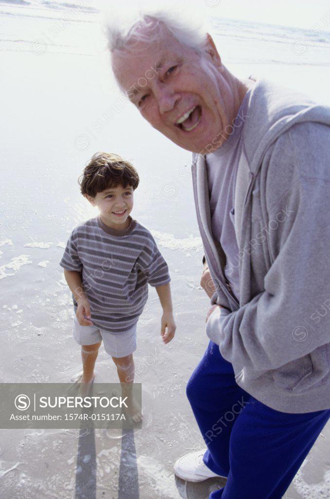 Stock Photo: 1574R-015117A Portrait of a grandfather laughing with his grandson on the beach
