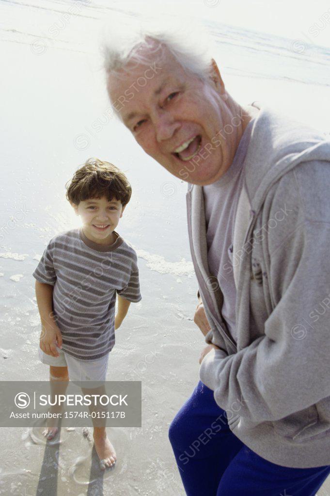 Stock Photo: 1574R-015117B Portrait of a grandfather laughing with his grandson on the beach