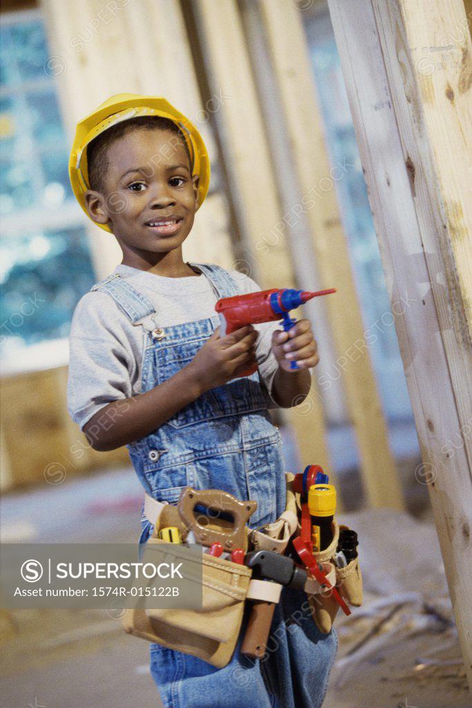Stock Photo: 1574R-015122B Portrait of a boy dressed as a construction worker holding a toy drill