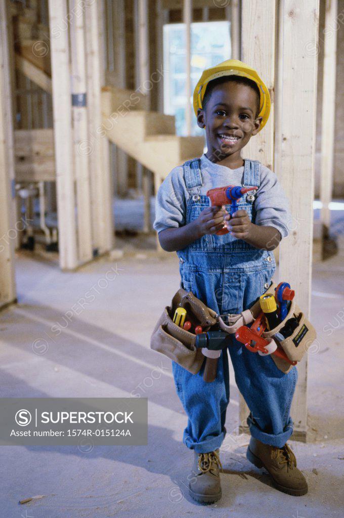 Stock Photo: 1574R-015124A Portrait of a boy dressed as a construction worker holding a toy drill
