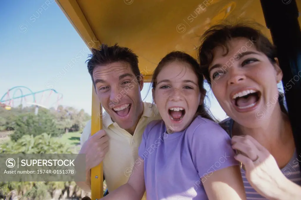Portrait of parents and their daughter laughing