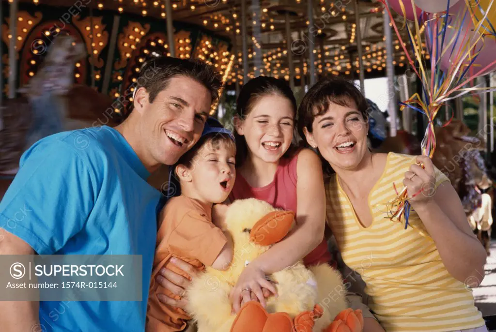 Parents with their son and daughter in an amusement park