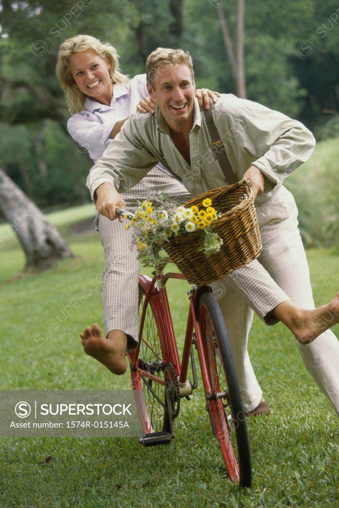 Stock Photo: 1574R-015145A Young couple riding a bicycle