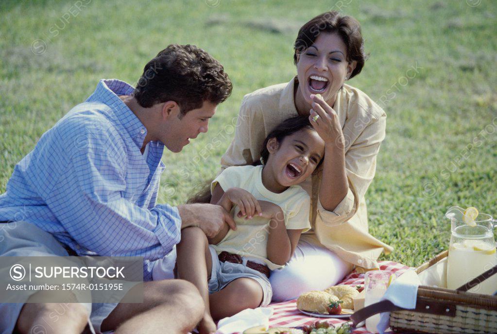 Stock Photo: 1574R-015195E Close-up of parents playing with their daughter in a park