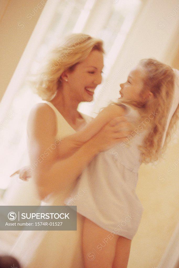 Stock Photo: 1574R-01527 Young woman lifting up her daughter