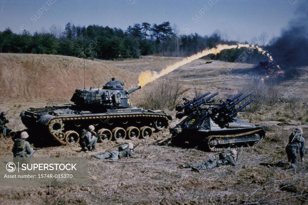 Stock Photo: 1574R-015370 Army soldiers with military tanks on a battlefield