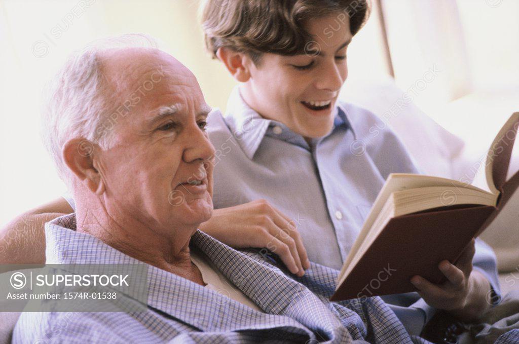 Stock Photo: 1574R-01538 Teenage boy reading to an elderly man
