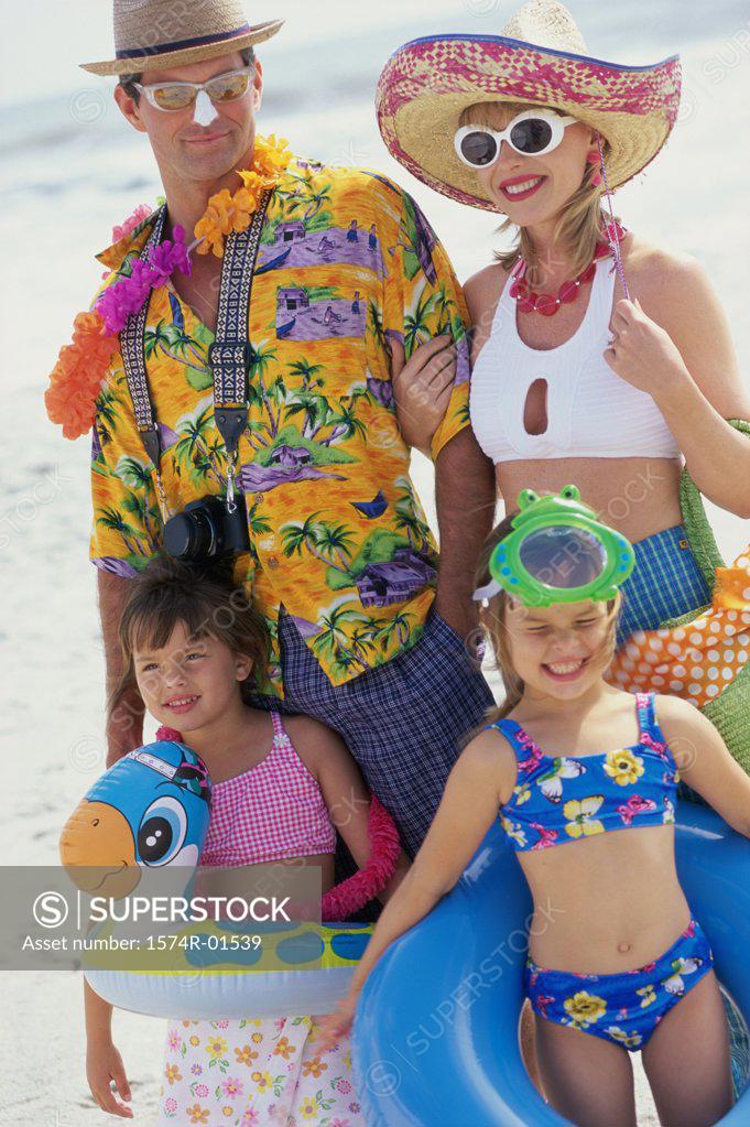 Stock Photo: 1574R-01539 Father and mother with their children at the beach