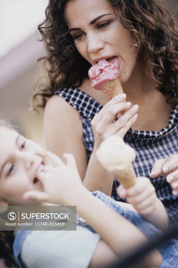 Stock Photo: 1574R-015419 Close-up of a mother eating ice cream with her daughter