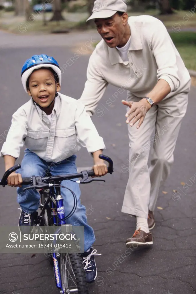Young man teaching his son to ride a bicycle