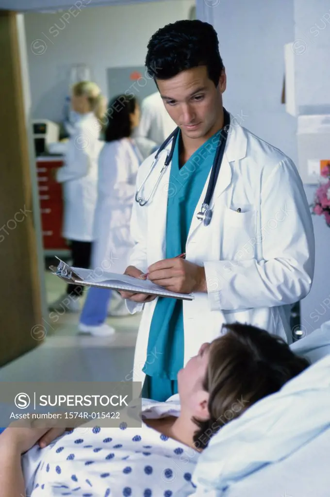 Male doctor taking the report of a patient