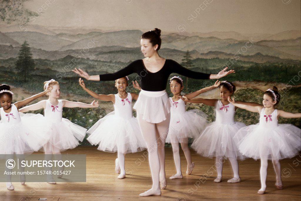 Stock Photo: 1574R-015427 Group of ballet dancers dancing with their teacher