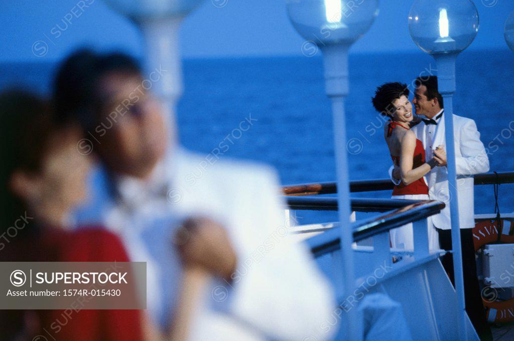 Stock Photo: 1574R-015430 Young couple dancing on the deck of a cruise ship