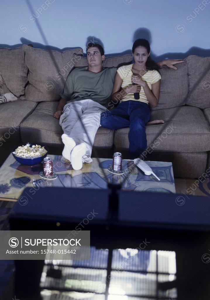 Stock Photo: 1574R-015442 High angle view of a young couple watching television