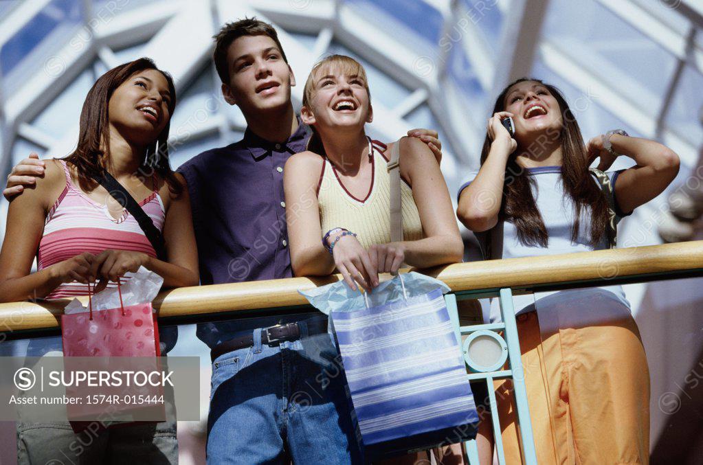 Stock Photo: 1574R-015444 Low angle view of three teenage girls and a teenage boy in a shopping mall