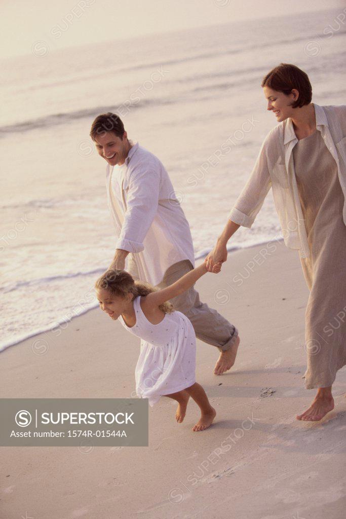 Stock Photo: 1574R-01544A Couple with their daughter on the beach