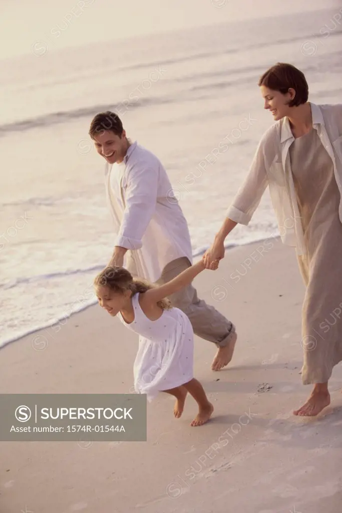 Couple with their daughter on the beach