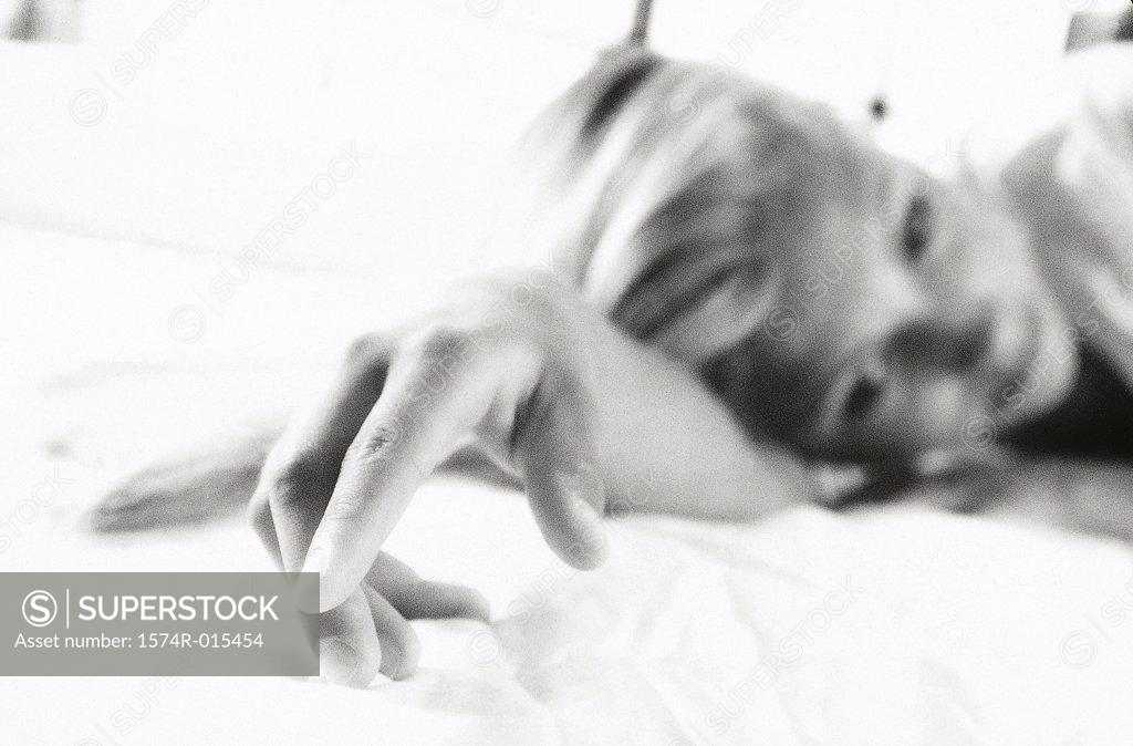 Stock Photo: 1574R-015454 Teenage girl lying on a bed