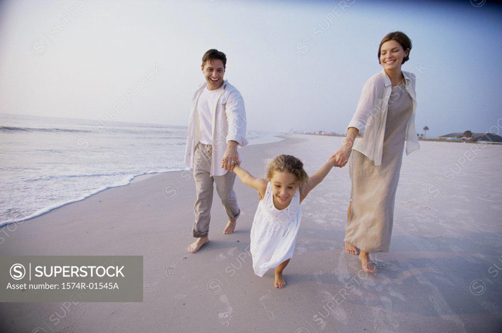 Stock Photo: 1574R-01545A Couple with their daughter on the beach