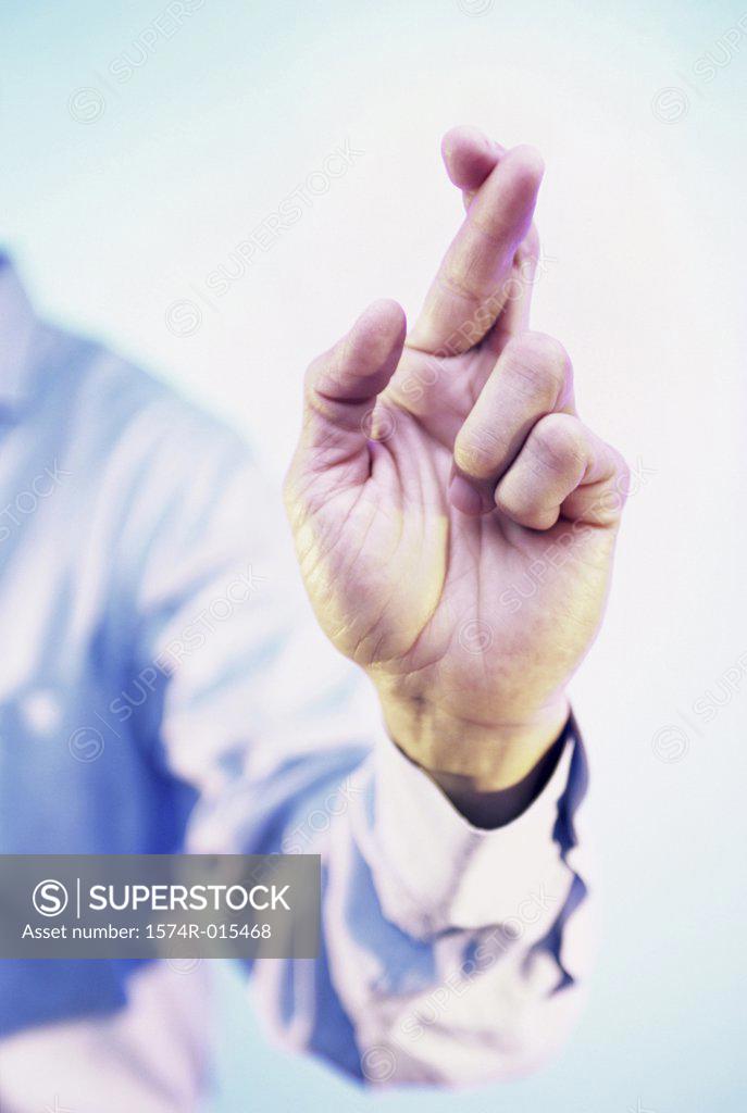 Stock Photo: 1574R-015468 Close-up of a businessman's fingers crossed