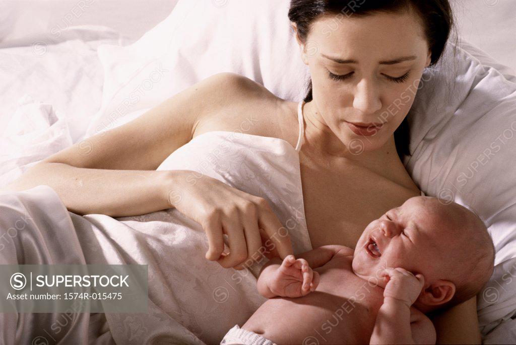 Stock Photo: 1574R-015475 High angle view of a mother lying in bed with her son