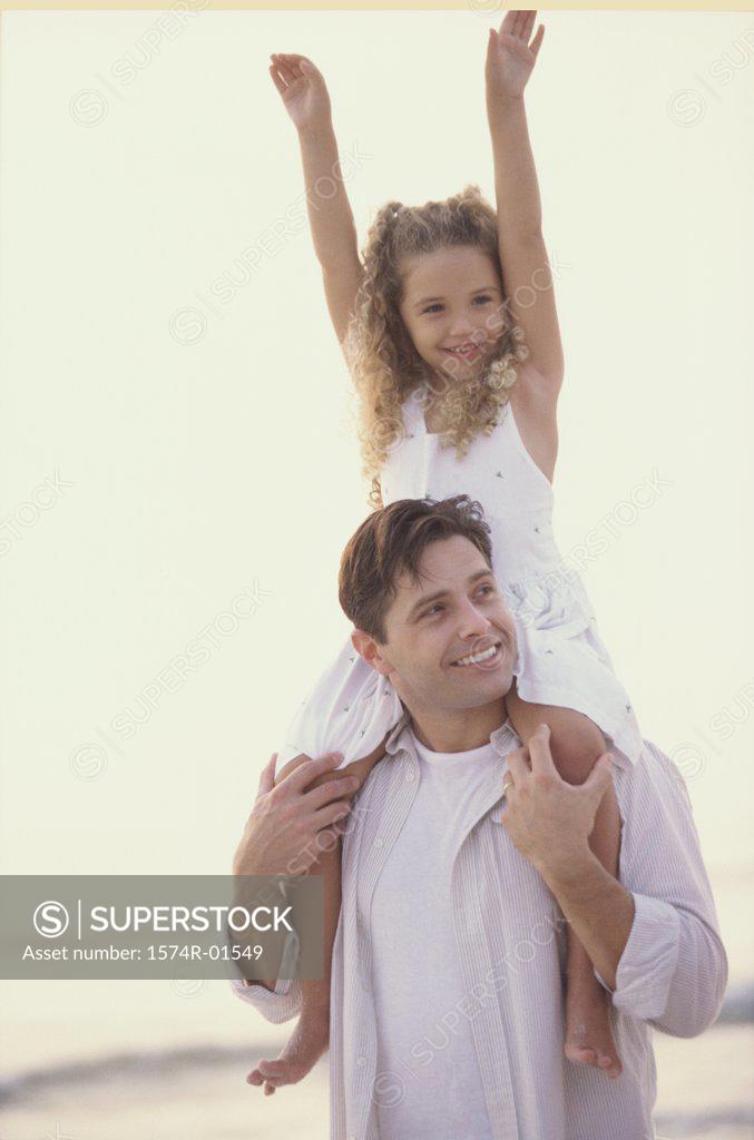 Stock Photo: 1574R-01549 Father carrying his daughter on his shoulders