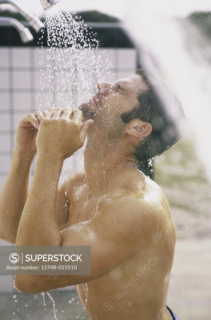 Stock Photo: 1574R-015510 Side profile of a young man in the shower