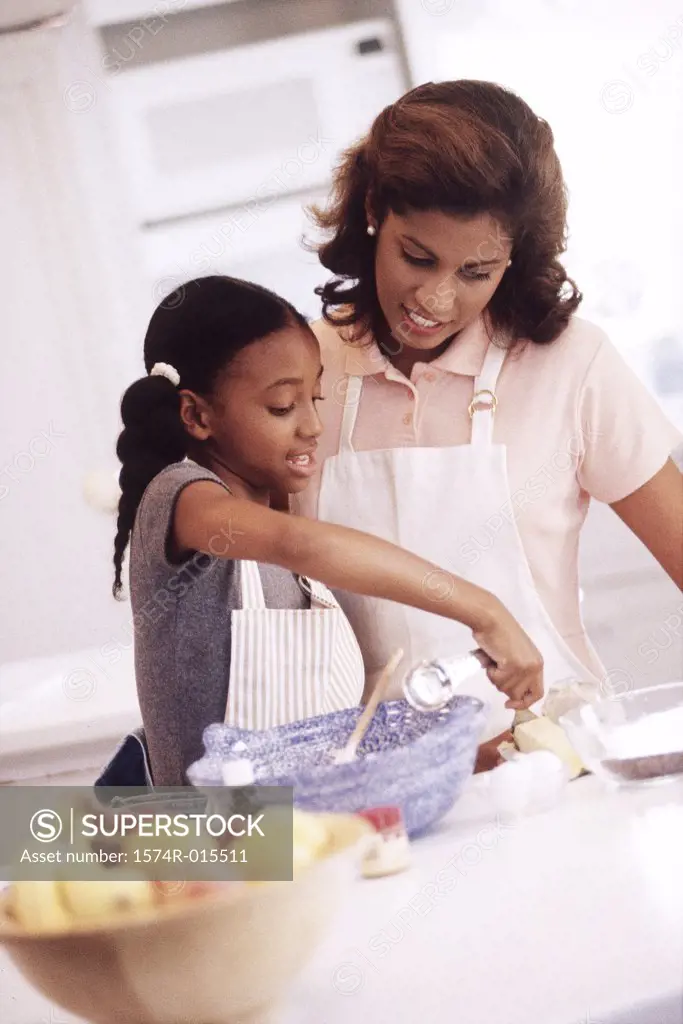 Mother and daughter preparing food in the kitchen