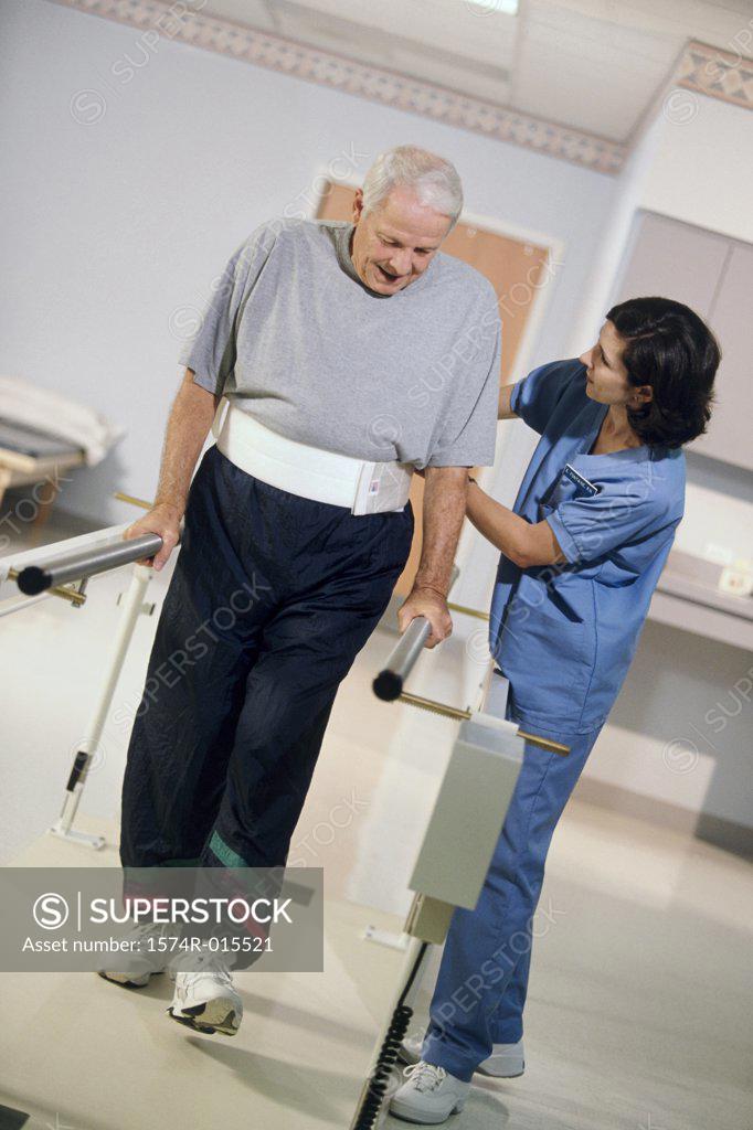 Stock Photo: 1574R-015521 Side profile of a female nurse helping a patient to walk