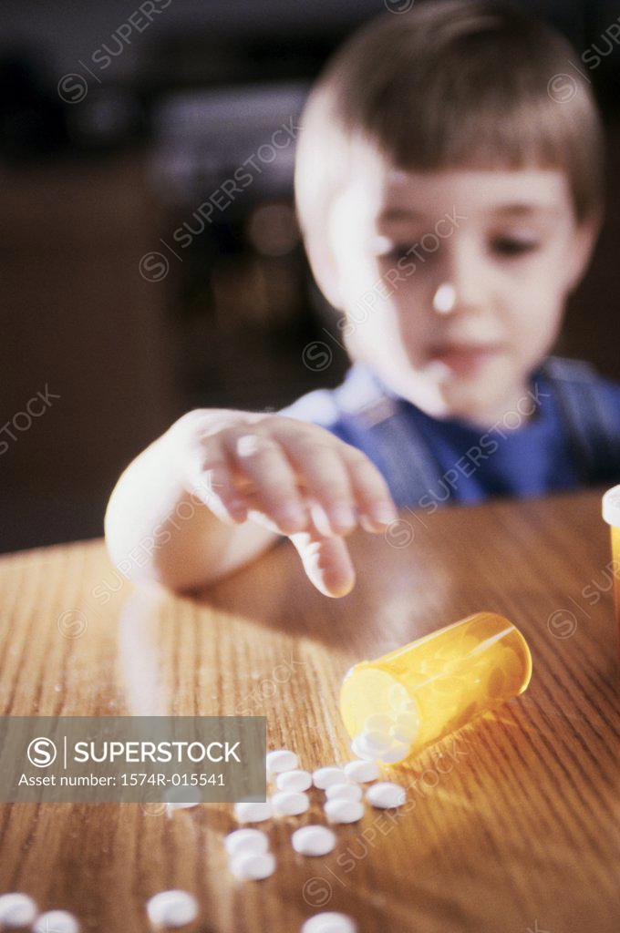 Stock Photo: 1574R-015541 Close-up of a boy reaching out for pills