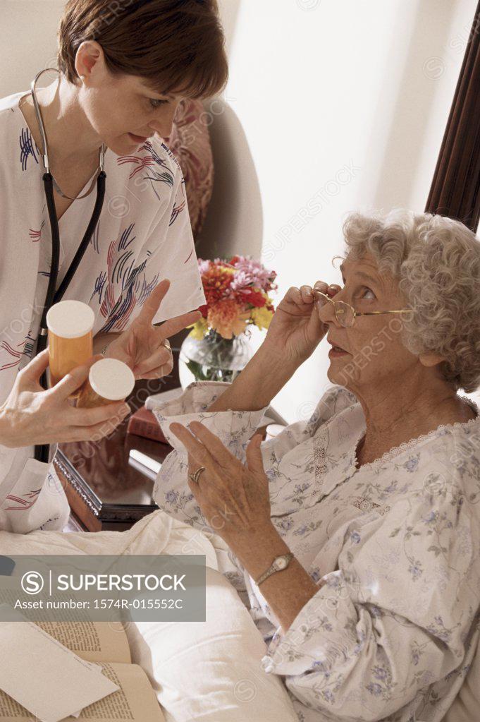 Stock Photo: 1574R-015552C Close-up of a female nurse giving prescription to a patient