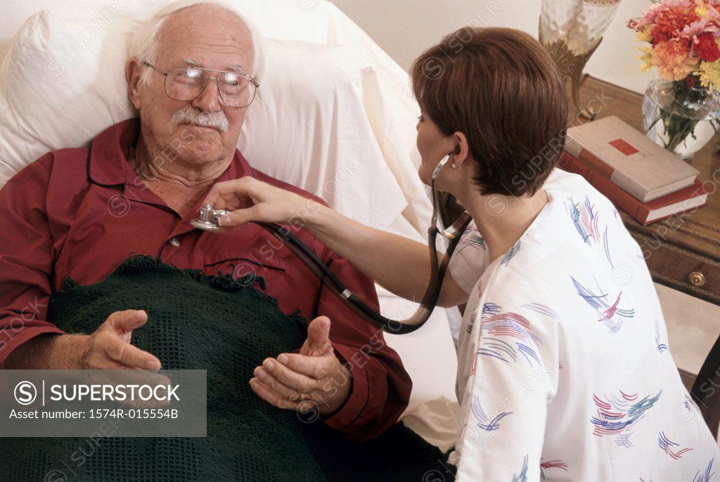 Stock Photo: 1574R-015554B High angle view of a female nurse examining a patient