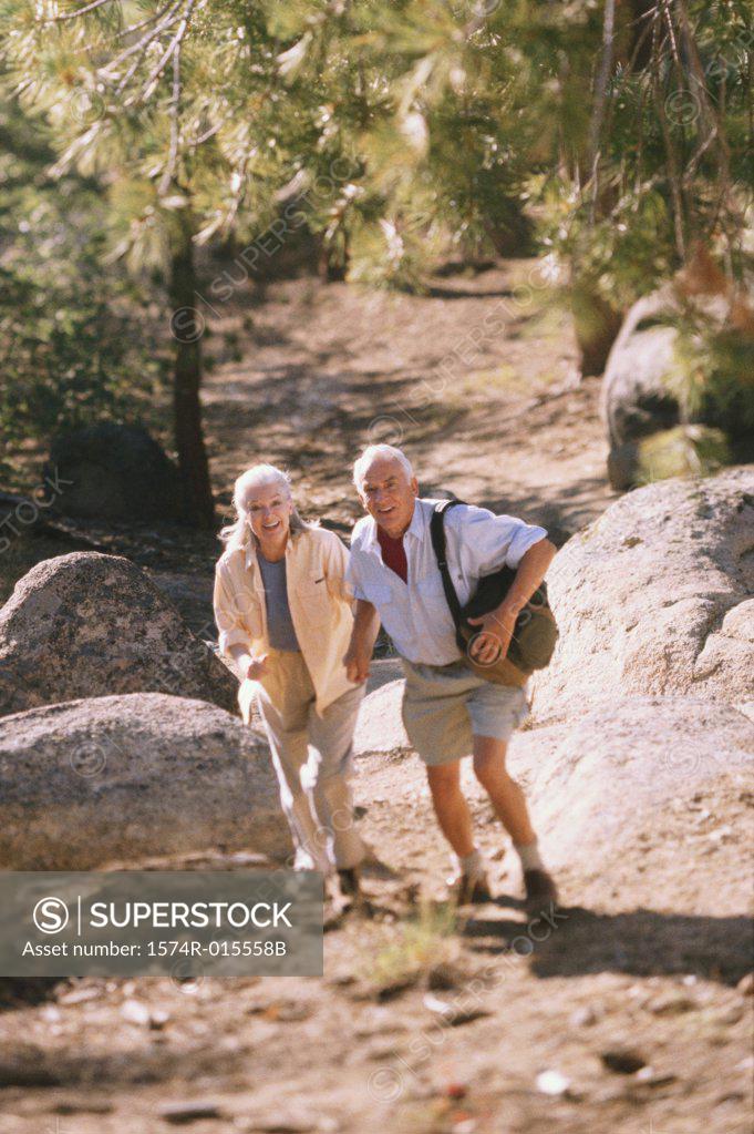Stock Photo: 1574R-015558B High angle view of a senior couple walking holding hands