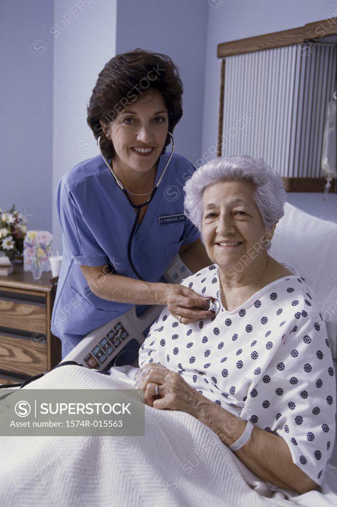 Stock Photo: 1574R-015563 Portrait of a female nurse examining a patient
