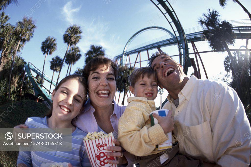 Stock Photo: 1574R-015581B Low angle view of parents with their son and daughter smiling in an amusement park