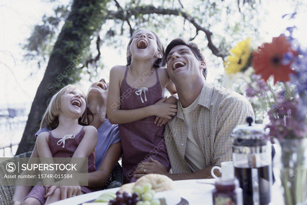 Stock Photo: 1574R-015584 Parents and their two daughters laughing