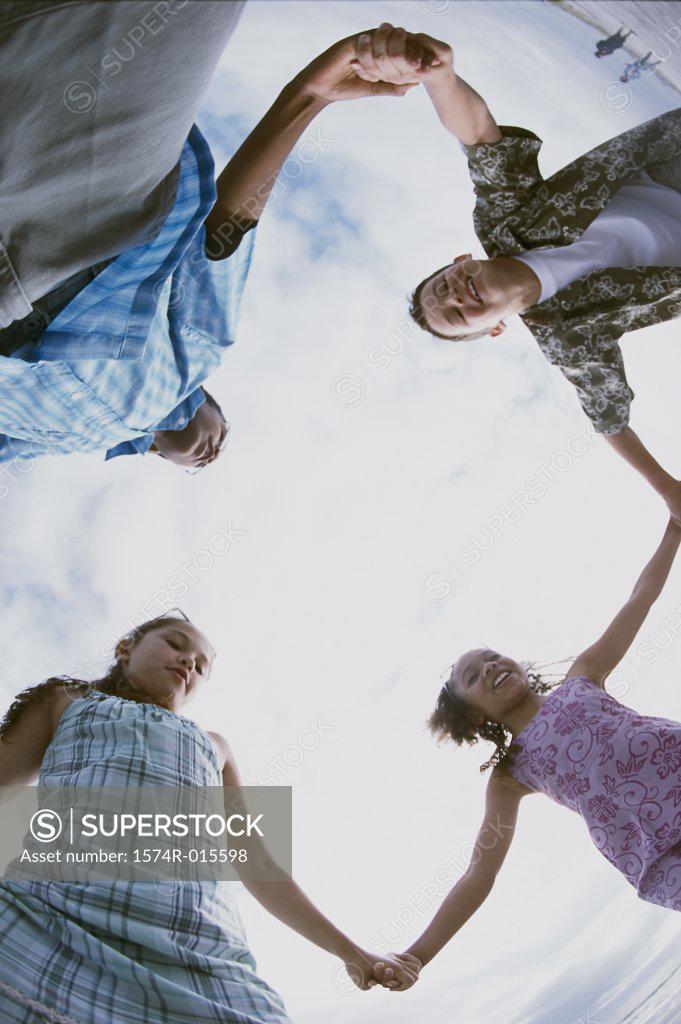 Stock Photo: 1574R-015598 Low angle view of two boys and two girls holding hands