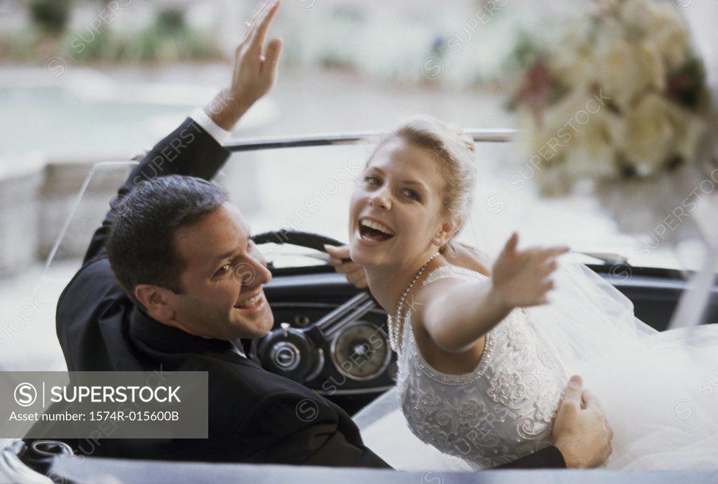 Stock Photo: 1574R-015600B Newlywed couple sitting in a convertible car