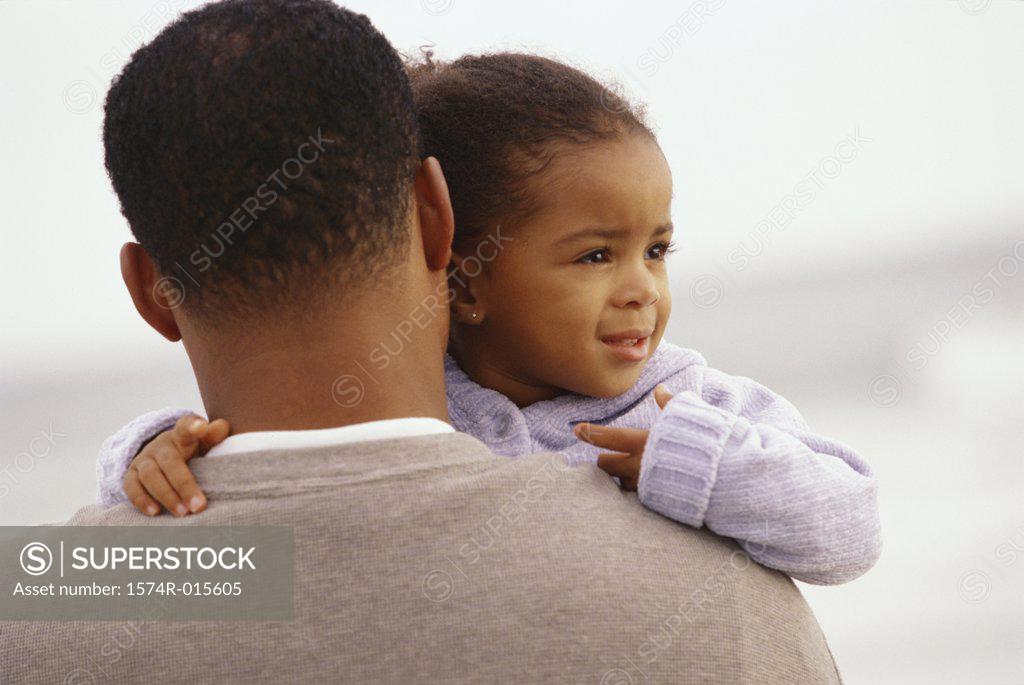 Stock Photo: 1574R-015605 Father carrying his daughter