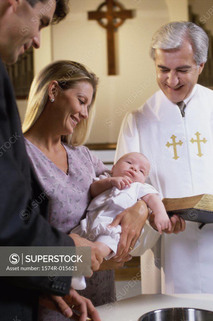 Stock Photo: 1574R-015621 Parents with their son at a baptism