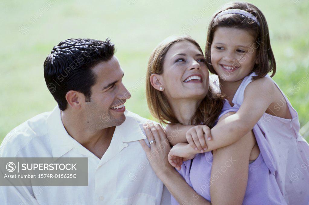 Stock Photo: 1574R-015625C Close-up of parents and their daughter smiling