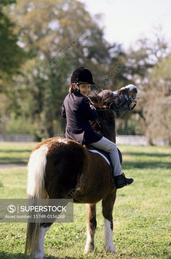 Stock Photo: 1574R-015626B Portrait of a girl riding a horse