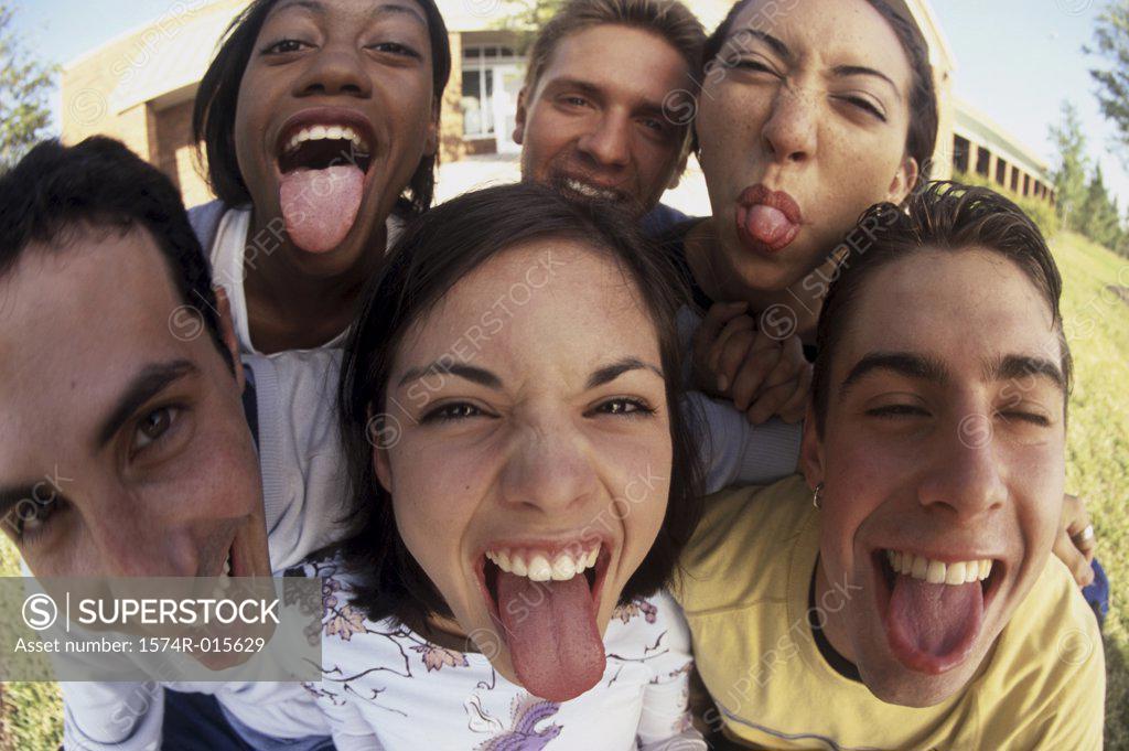 Stock Photo: 1574R-015629 Portrait of a group of teenagers sticking out their tongues