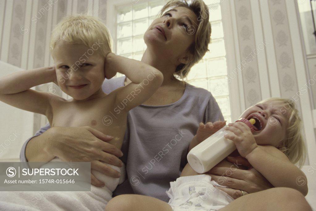 Stock Photo: 1574R-015646 Low angle view of a mother holding her son and daughter