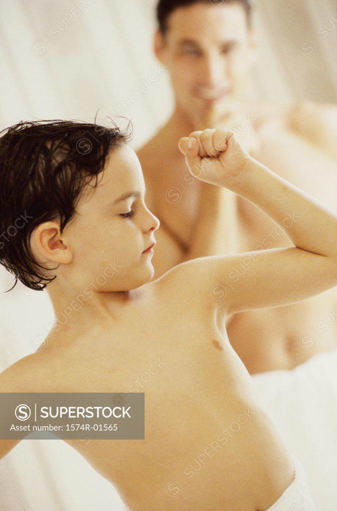 Stock Photo: 1574R-01565 Close-up of a boy flexing his muscles for his father