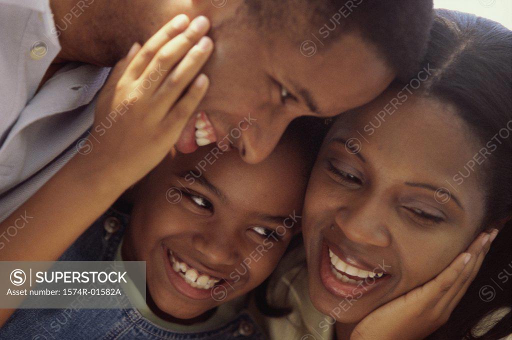 Stock Photo: 1574R-01582A Close-up of parents and their daughter smiling