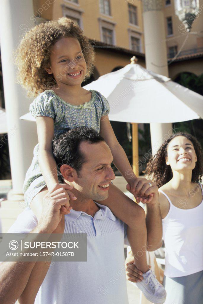 Stock Photo: 1574R-01587B Daughter sitting on her father's shoulders