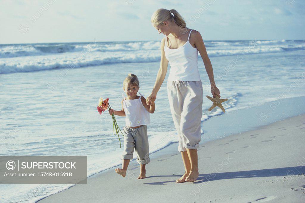 Stock Photo: 1574R-01591B Mother and daughter walking on the beach