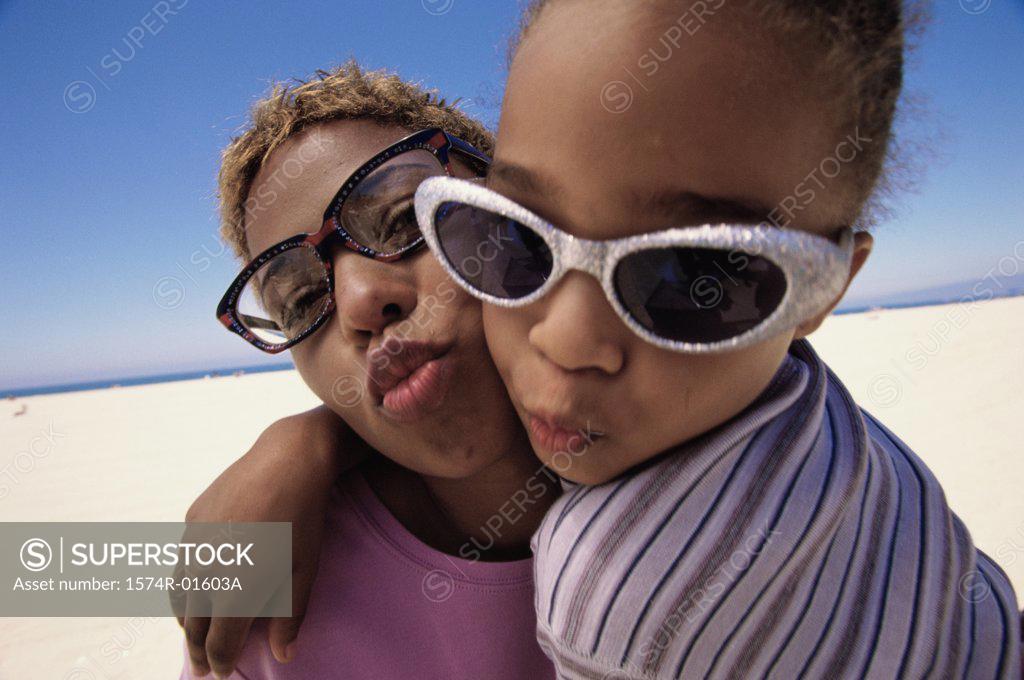 Stock Photo: 1574R-01603A Close-up of a mother and daughter puckering their lips